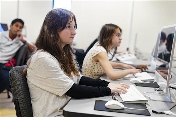 WEB DESIGN & INTERACTIVE MEDIA students working on computers